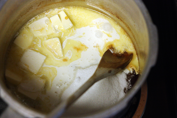 Mixing in butter, sugar, maple, and cream